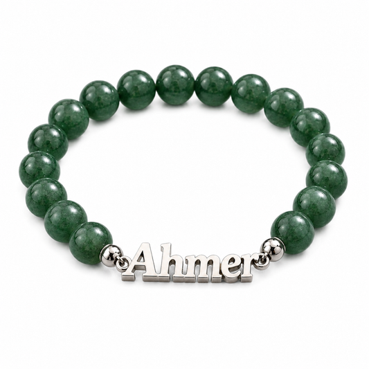 Green beaded bracelet with a silver name tag on a white background