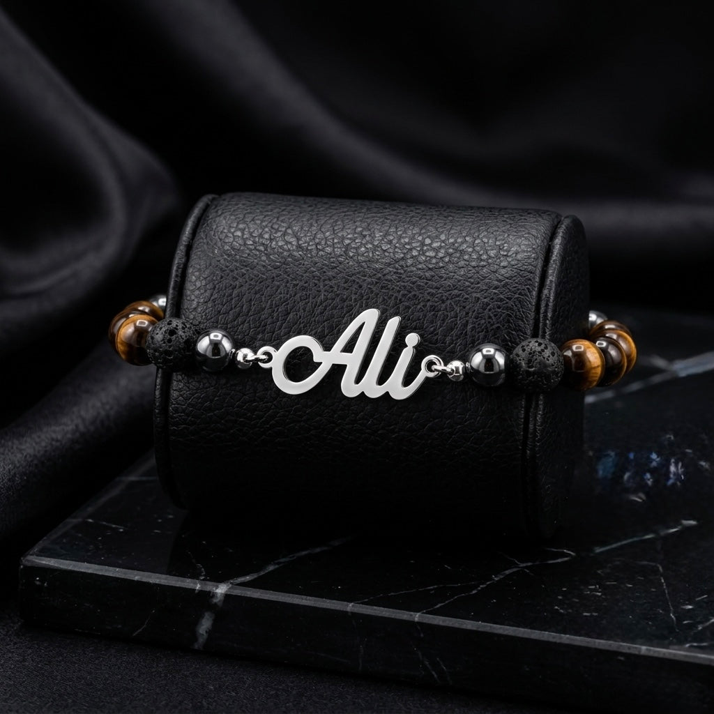 Bracelet with 'Ali' charm on a black leather case against a dark background