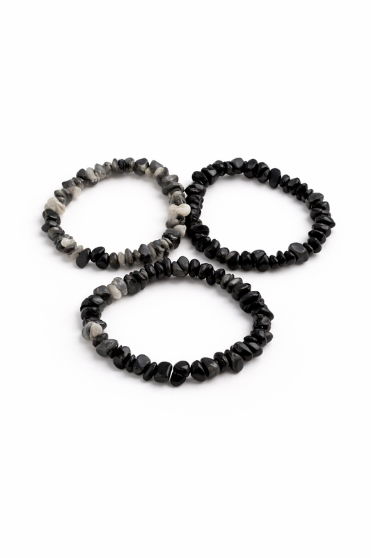 Three black and gray beaded bracelets on a white background
