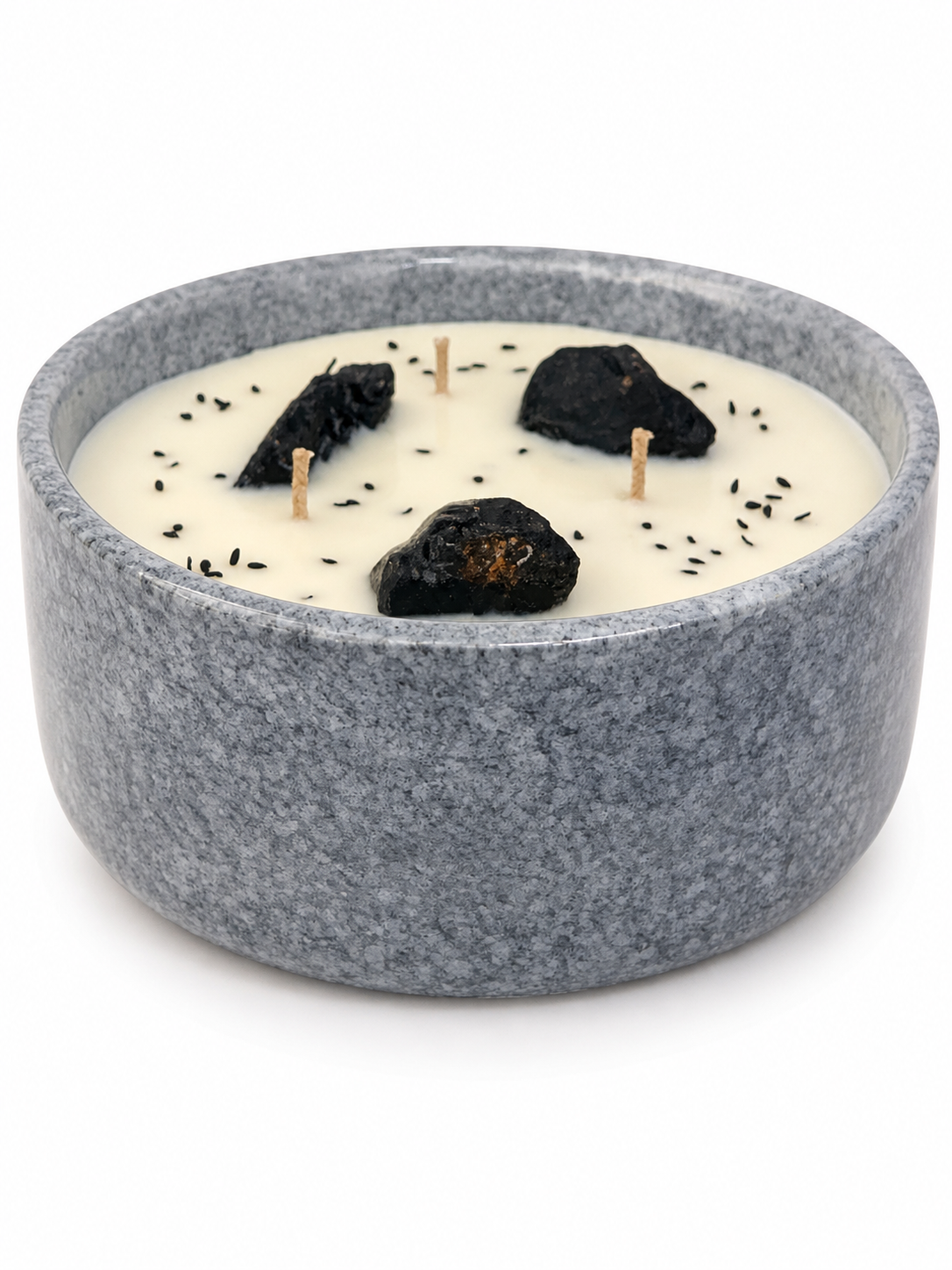 Candle in a gray stone bowl with blackberries on a white background