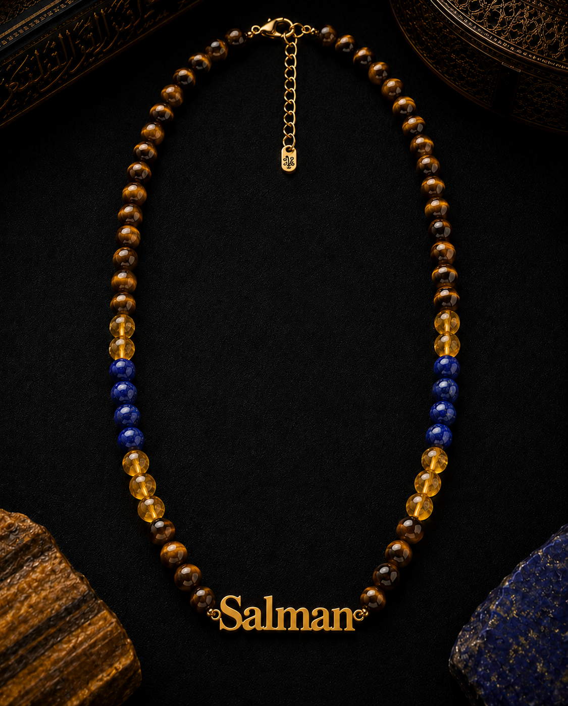 Necklace with brown and blue beads on a dark background, featuring the brand 'Salman'.