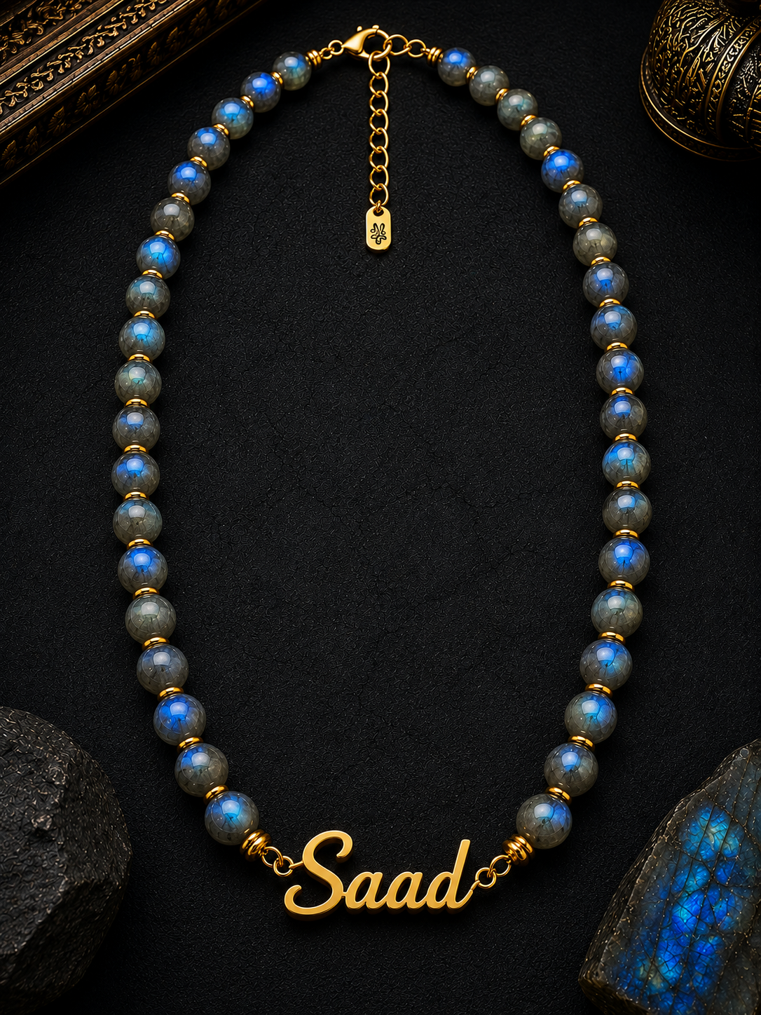 Necklace with blue beads and gold chain on a dark background