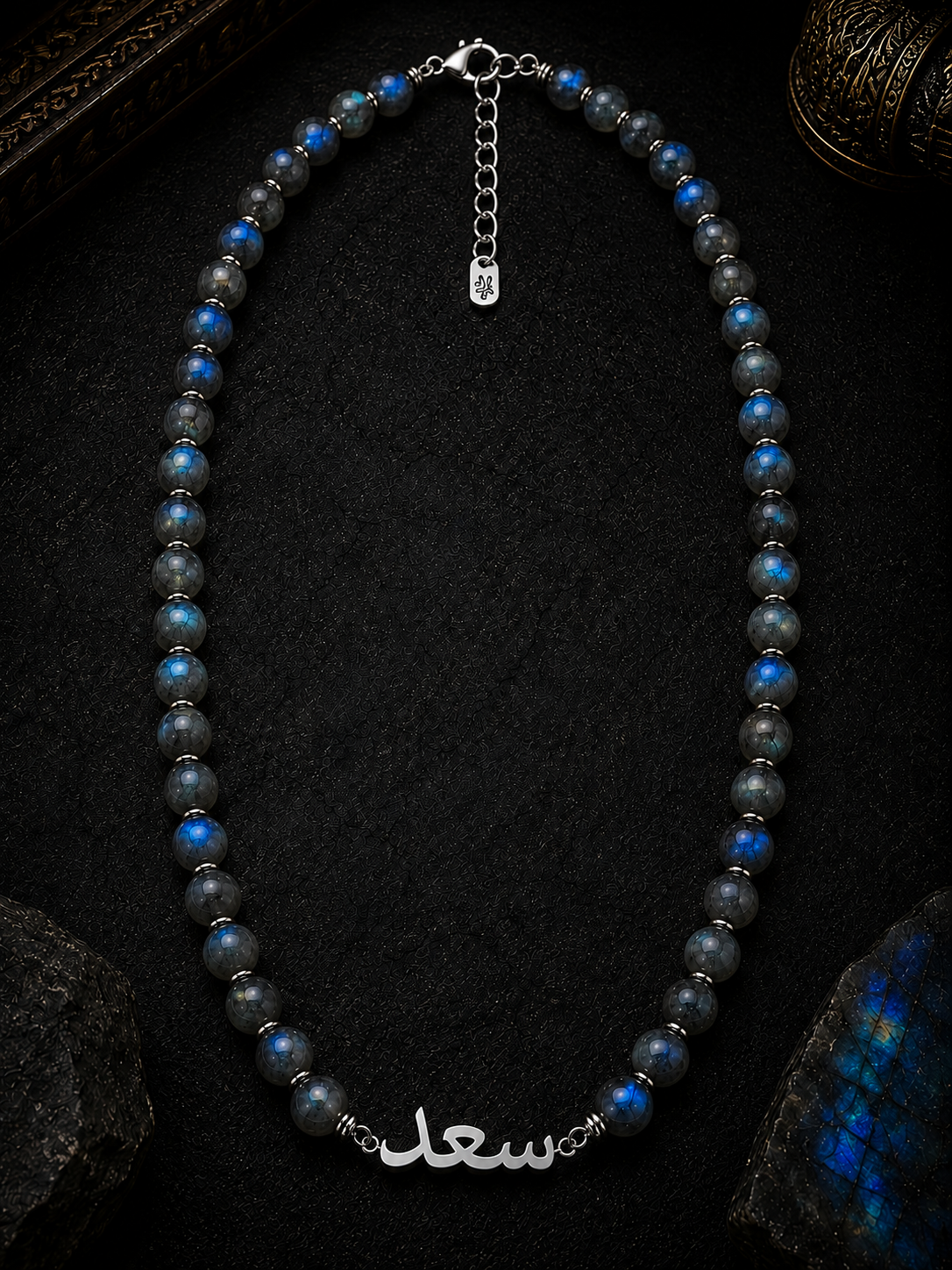 Necklace with blue and gray beads on a dark background