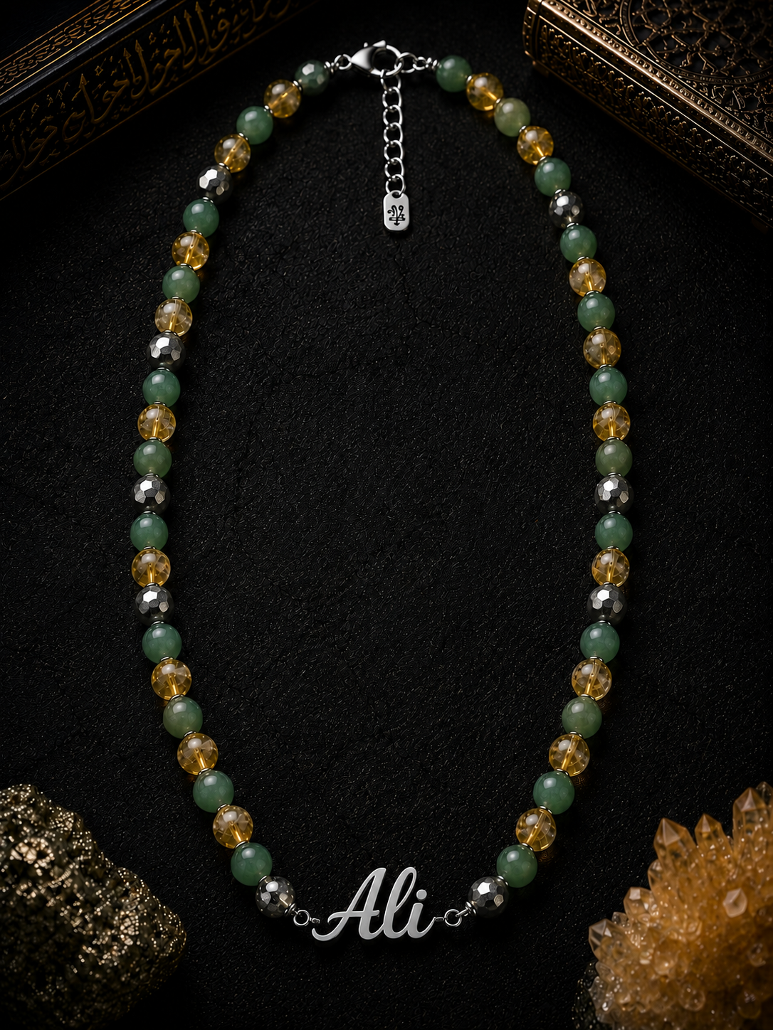 Beaded necklace with 'Ali' nameplate on a dark background