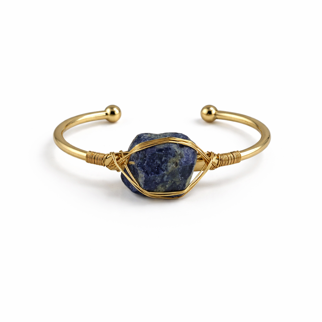 Gold bracelet with a blue stone on a white background