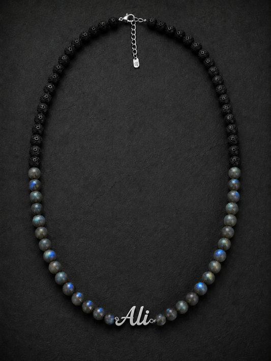 Necklace with black and gray beads and a nameplate on a dark background