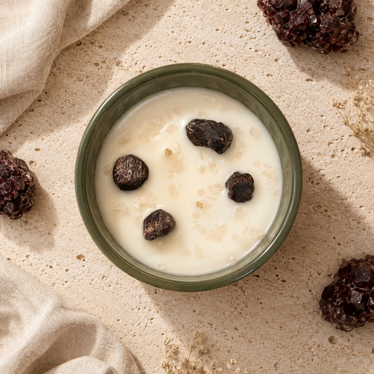 Green bowl of creamy dessert with raisins on a beige surface