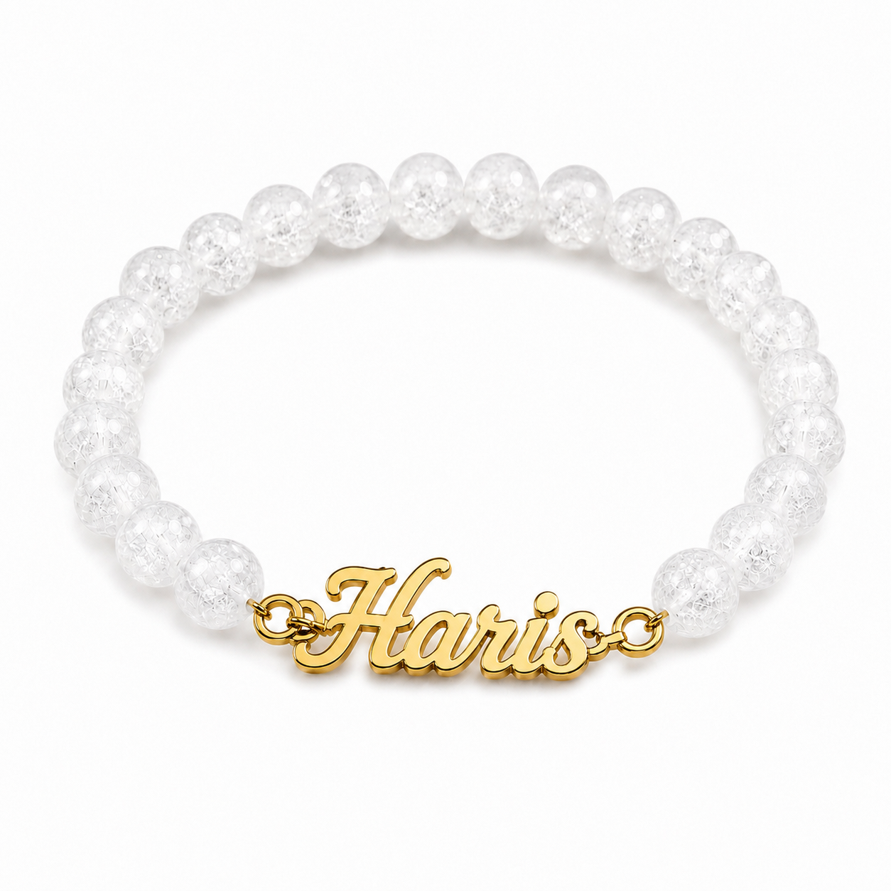 White beaded bracelet with a gold 'Harris' charm on a white background
