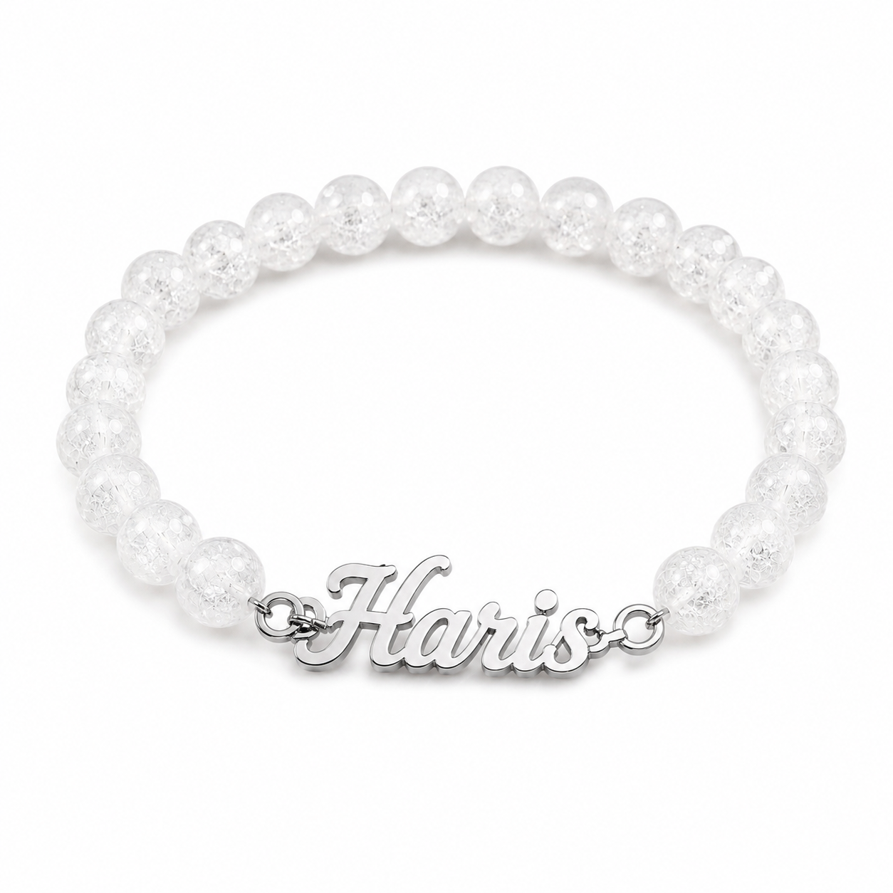 Pearl bracelet with a silver 'Harris' charm on a white background