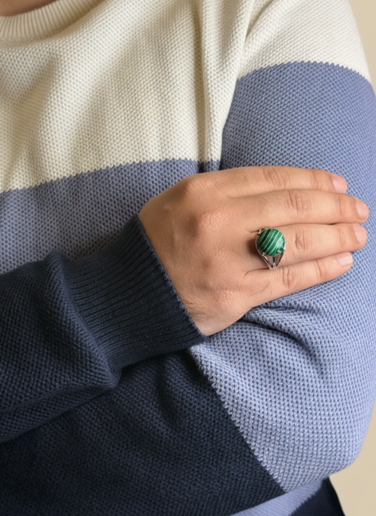 Close up of a Malachite stone ring on a man’s hand in a silver setting