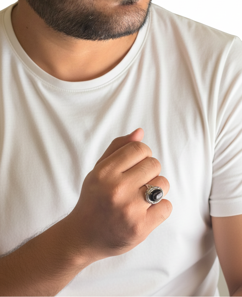 Man wearing a white t-shirt holding a ring with a white background