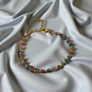 GemWhirl Stone: Multi-Tourmaline Beads with Gold-Toned Accents Purpose: Attracts joyful connections, multiplies social charm, and opens doors for new romantic or creative opportunities.